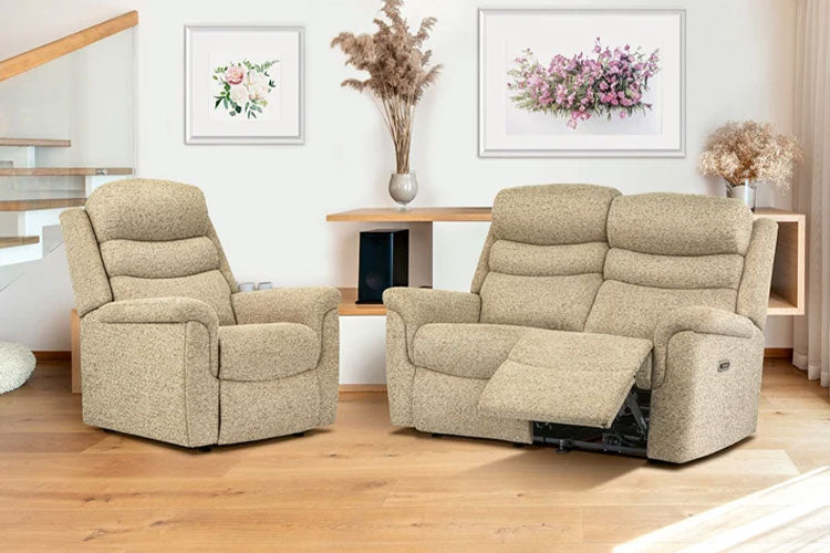 Beige recliner chairs in a living room setting with wooden flooring and decorative elements.