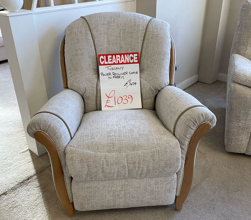 curvy power recliner chair with wooden trim in a showroom