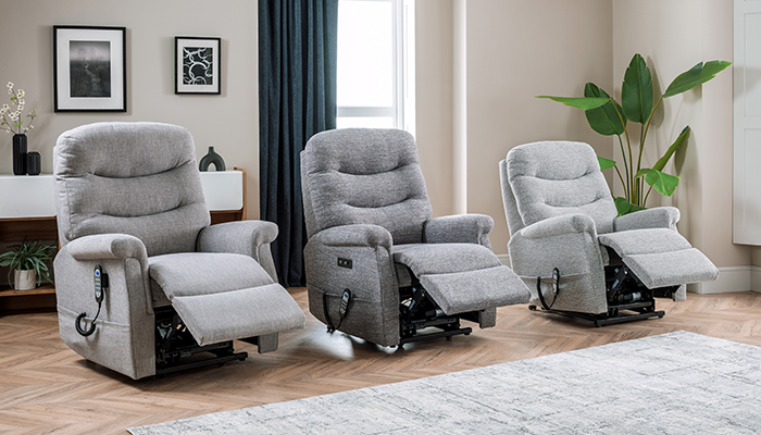 Three gray recliner chairs in a living room setting with decor elements.