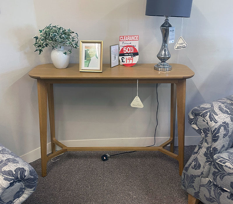 Wooden console table with decorative items in a furniture showroom setting