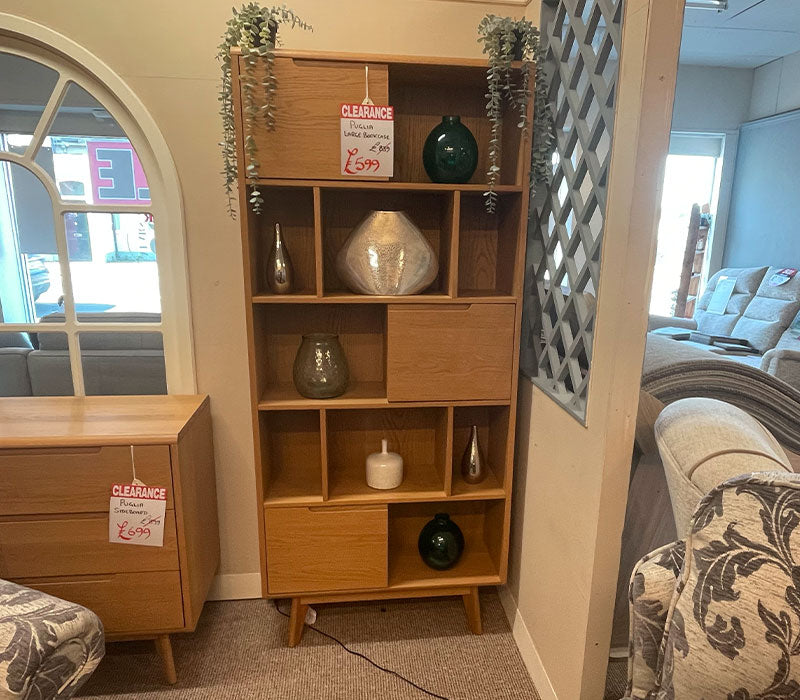 Wooden bookshelf with decorative items in a furniture showroom
