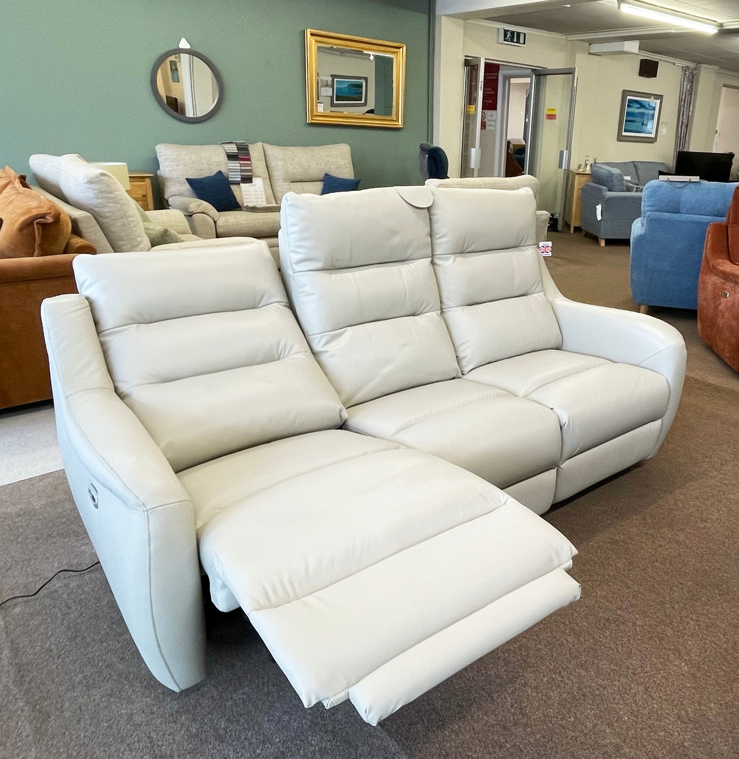 3 seater leather sofa with one side reclining in image